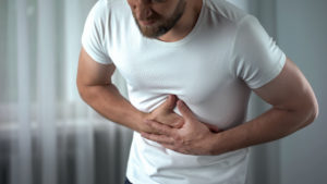 Man suffering bellyache at home, gastritis symptom, peptic ulcer, pancreatitis