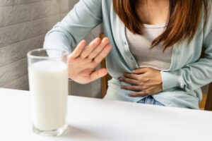 Female gesturing stop or say no to drink milk. Lactose intolerance,
