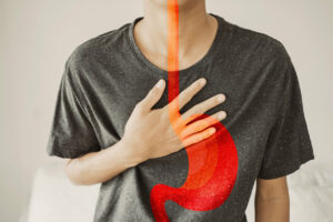 A young man is experiencing heartburn, Gastroesophageal reflux disease (GERD) or acid reflux symptoms.