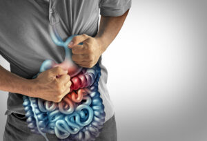 Image of a man with Crohn's disease holding his stomach, showing IBS symptoms.