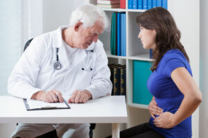 A patient with crohn's disease symptoms is explaining her condition to the gastrointestinal doctor.