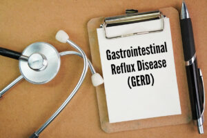 A stethoscope and a whiteboard with the word Gastrointestinal Reflux Disease (GERD).